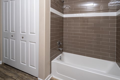 A white door with a glass window is in a bathroom.