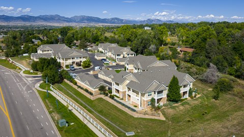 A large, well-maintained residential complex with multiple houses and a clear sky.