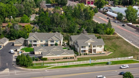 A suburban neighborhood with houses and a busy road.