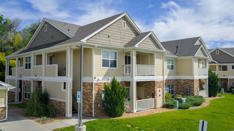 A row of houses with a blue sky in the background.