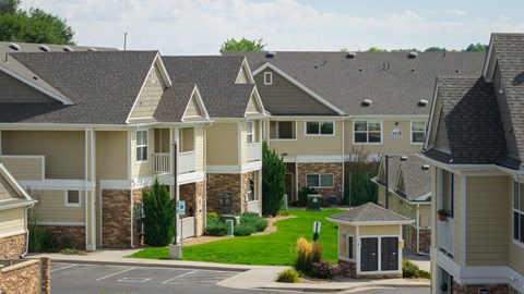 A view of apartment buildings with a small gazebo in the front.