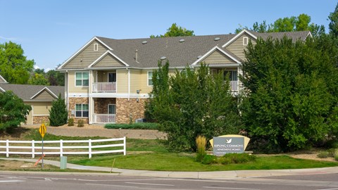 A large house with a white fence in front of it.