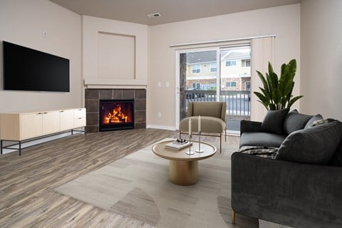 A modern living room with a fireplace and a flat screen TV.