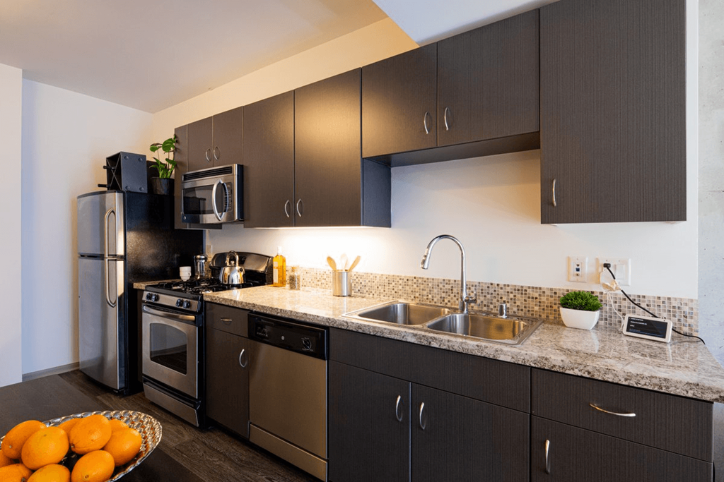 a kitchen with stainless steel appliances and granite counter tops