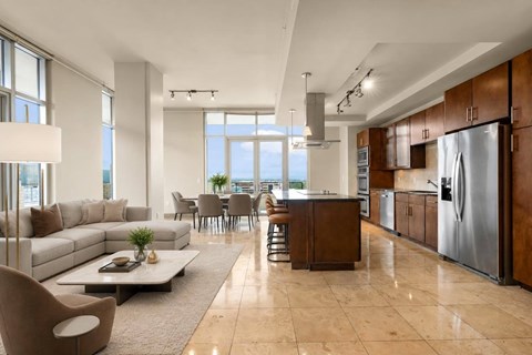 A modern kitchen with a refrigerator, sink, and stove.
