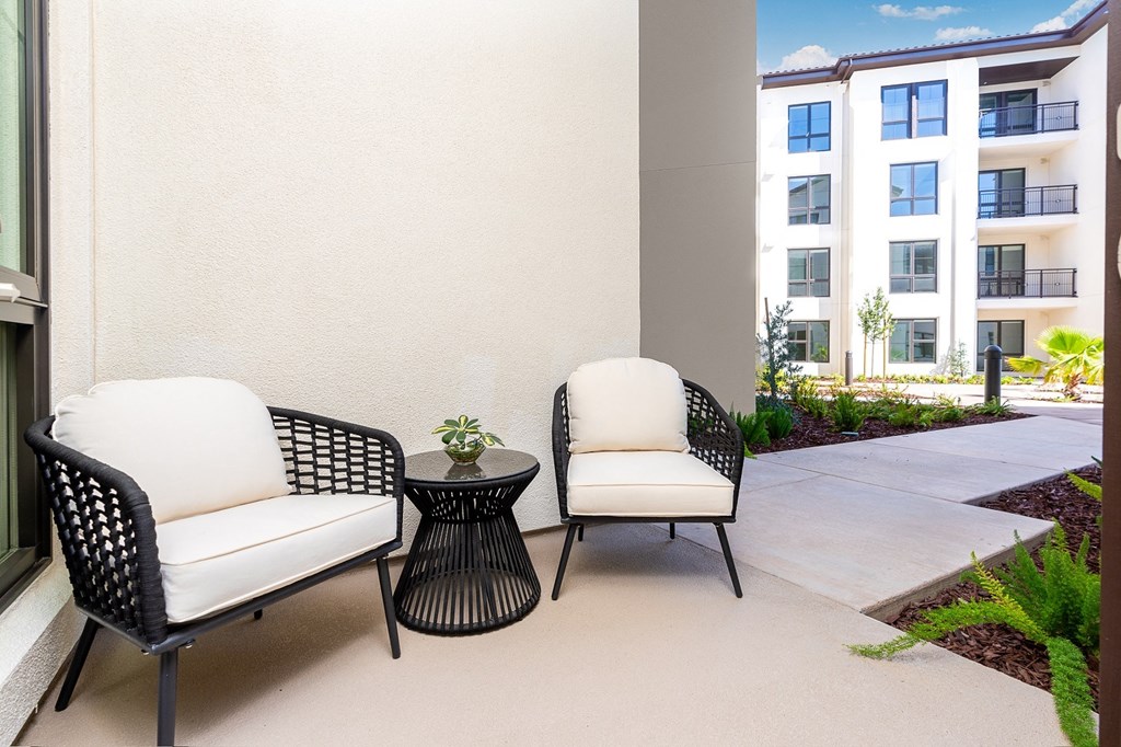 a patio with two chairs and a small table