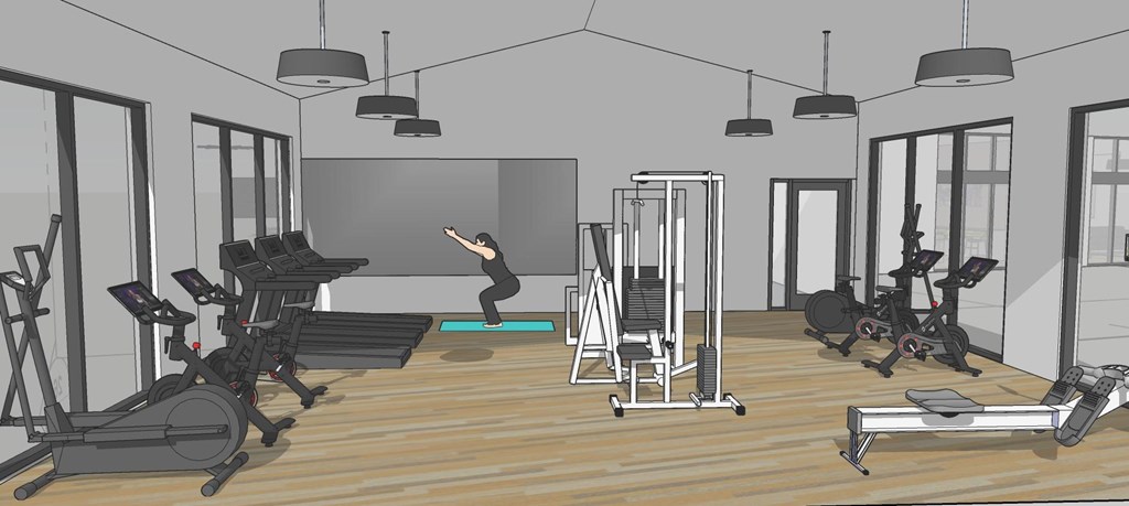 A person is exercising in a gym with a variety of equipment.