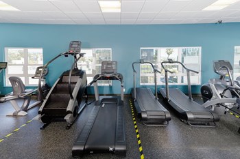 Metwest apartments' gym space with assorted walkers and a stair climber. Metwest apartments' gym space with assorted walkers and a stair climber. - Photo Gallery 4