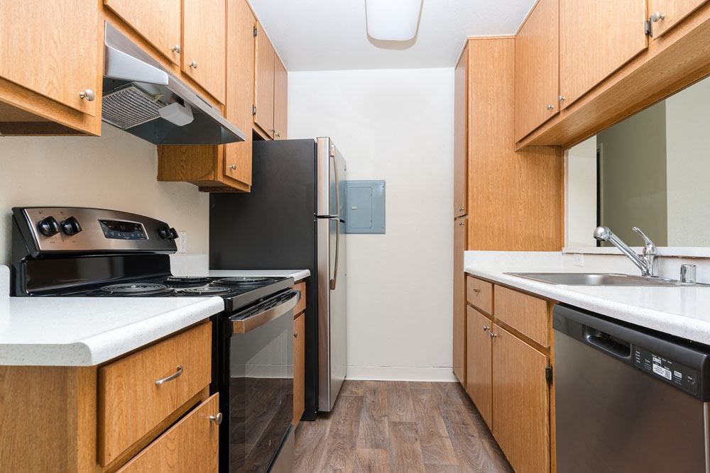 a kitchen with a stove refrigerator and sink
