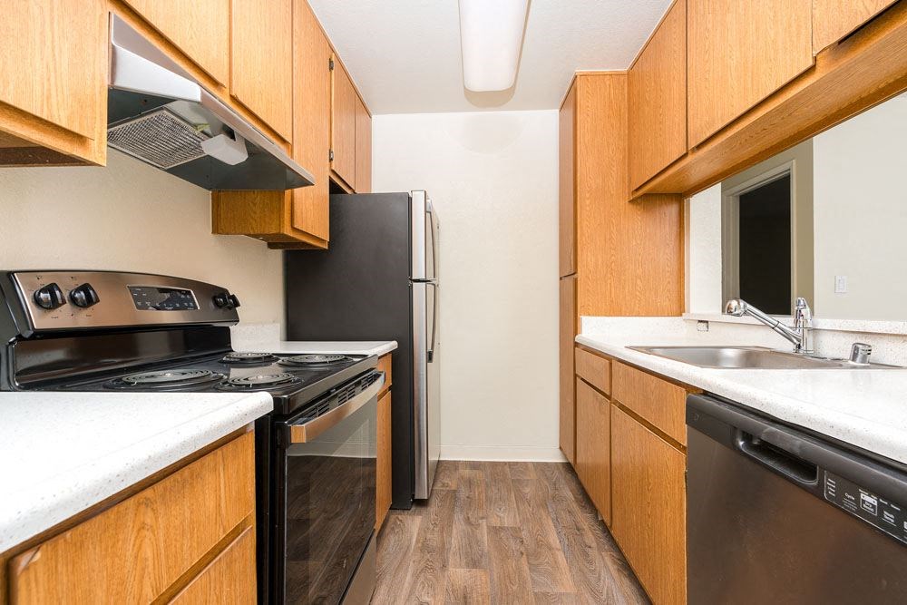 a kitchen with a stove refrigerator and sink