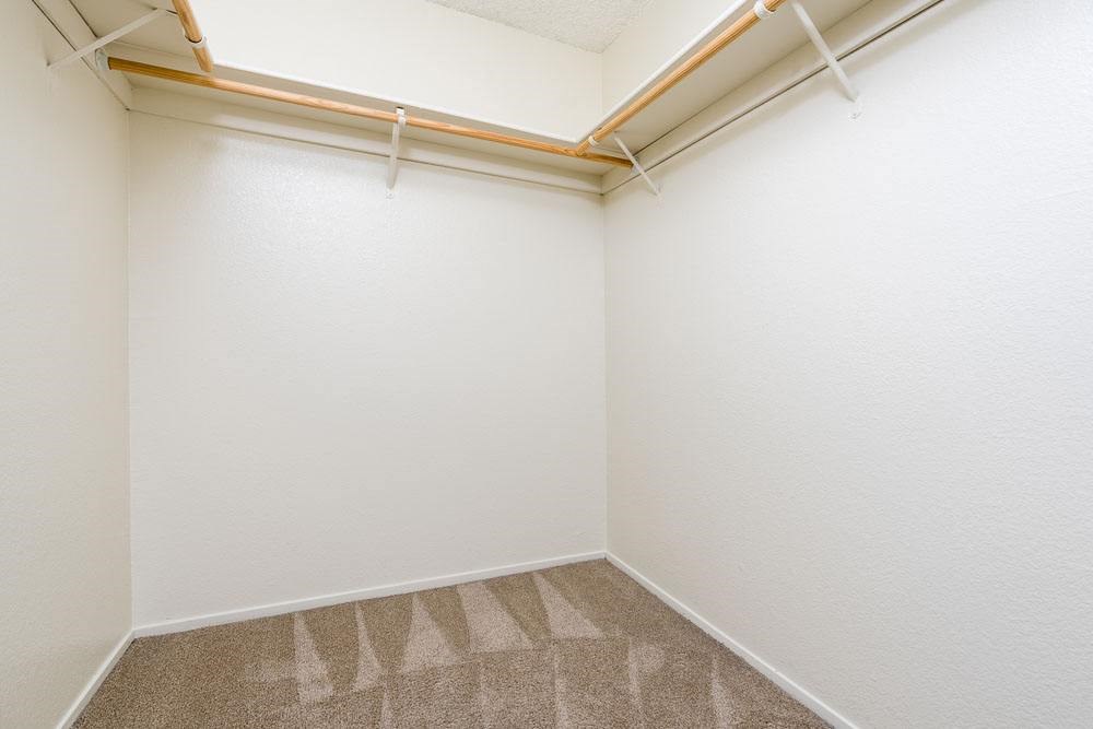 an empty room with white walls and a window