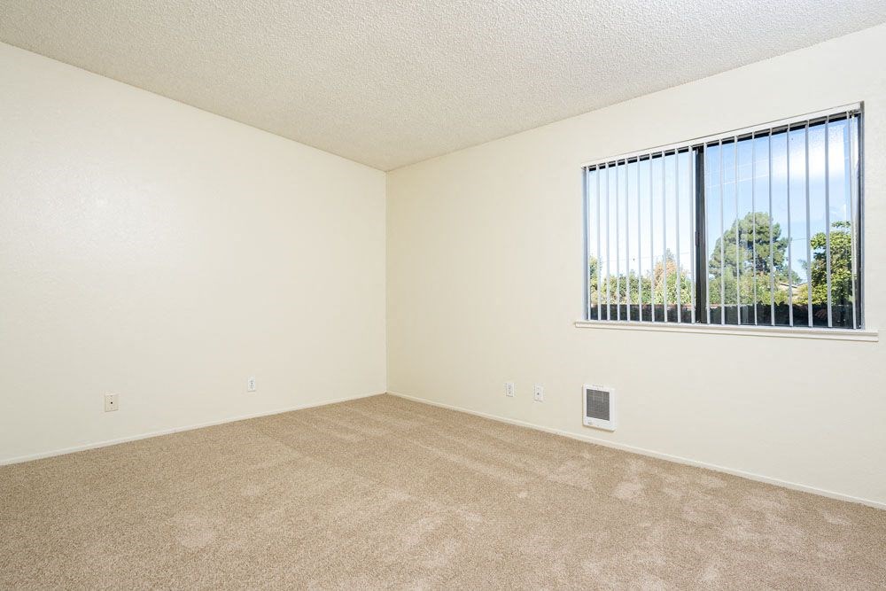 an empty living room with a large window