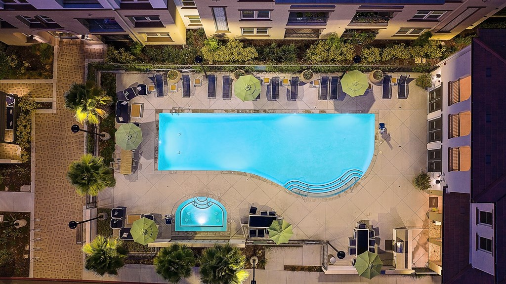 a view of the pool from above at the hotel at night