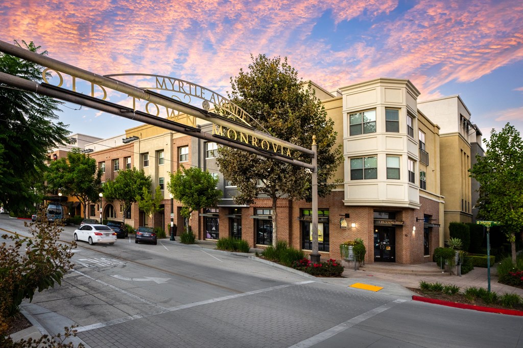 a street view of a building with a sign for the entrance to an apartment complex