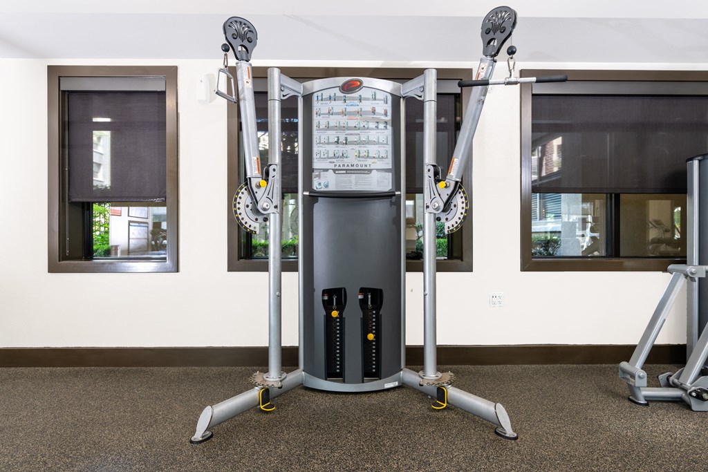 an exercise machine in a fitness room with windows