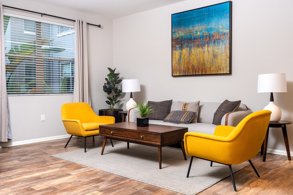 a living room with yellow chairs and a couch