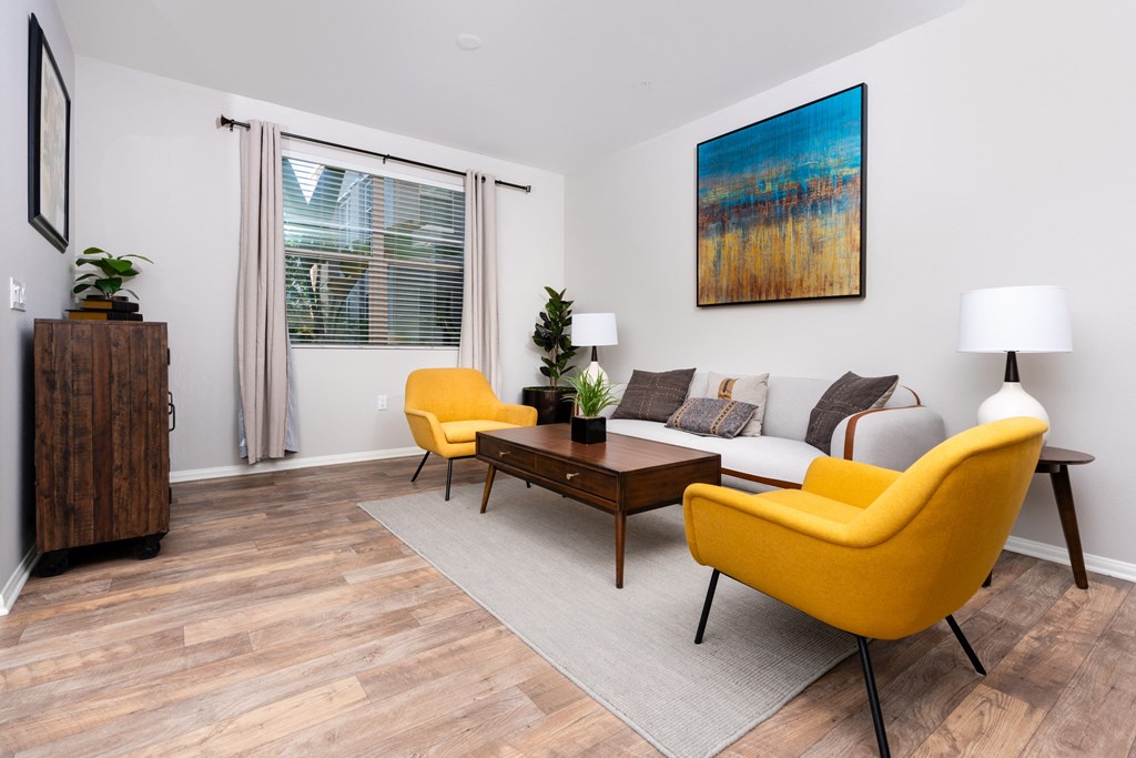 a living room with yellow chairs and a couch