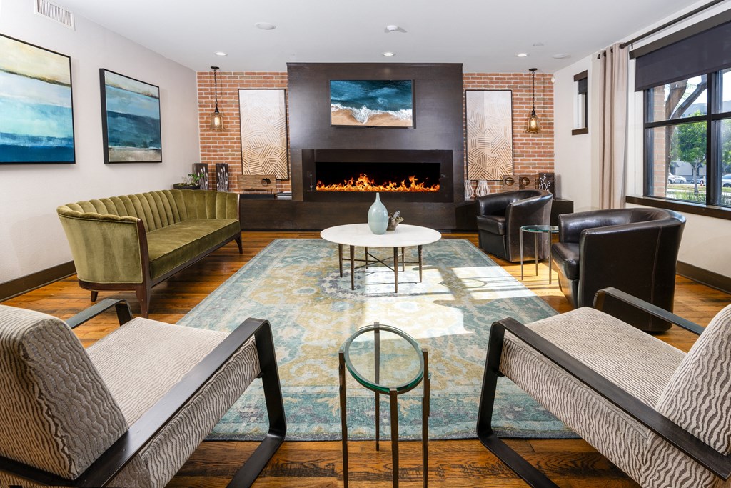 a living room with couches and chairs and a fireplace