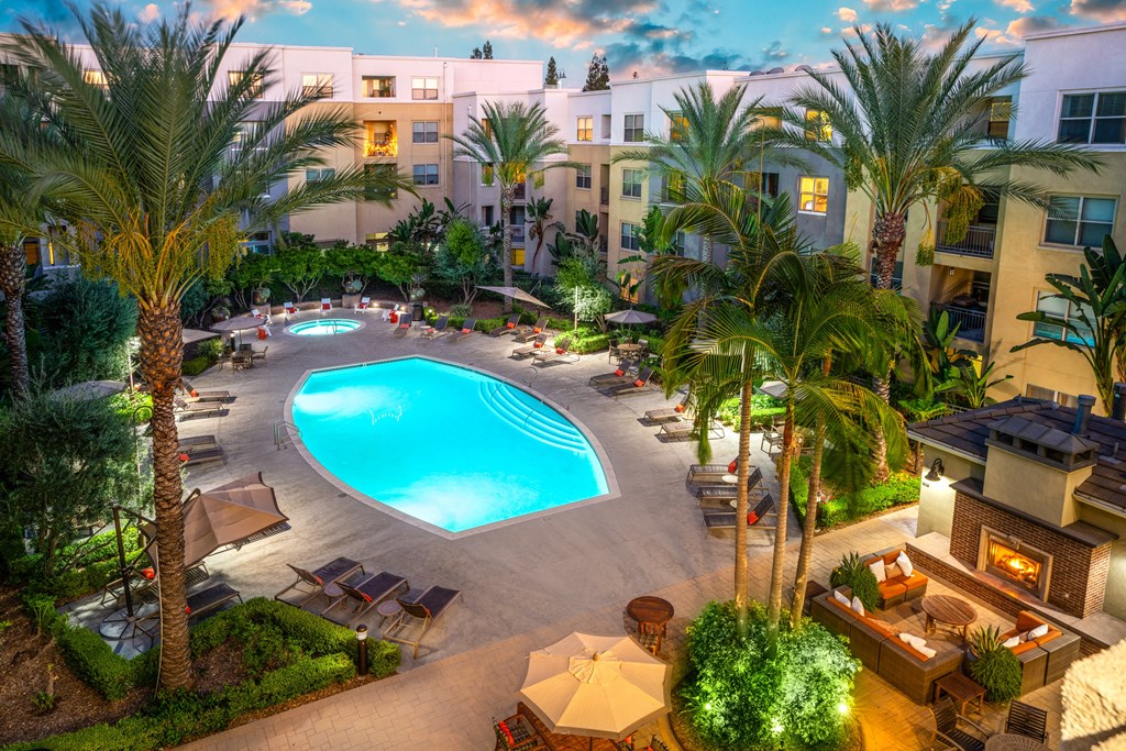 a swimming pool at a hotel with palm trees