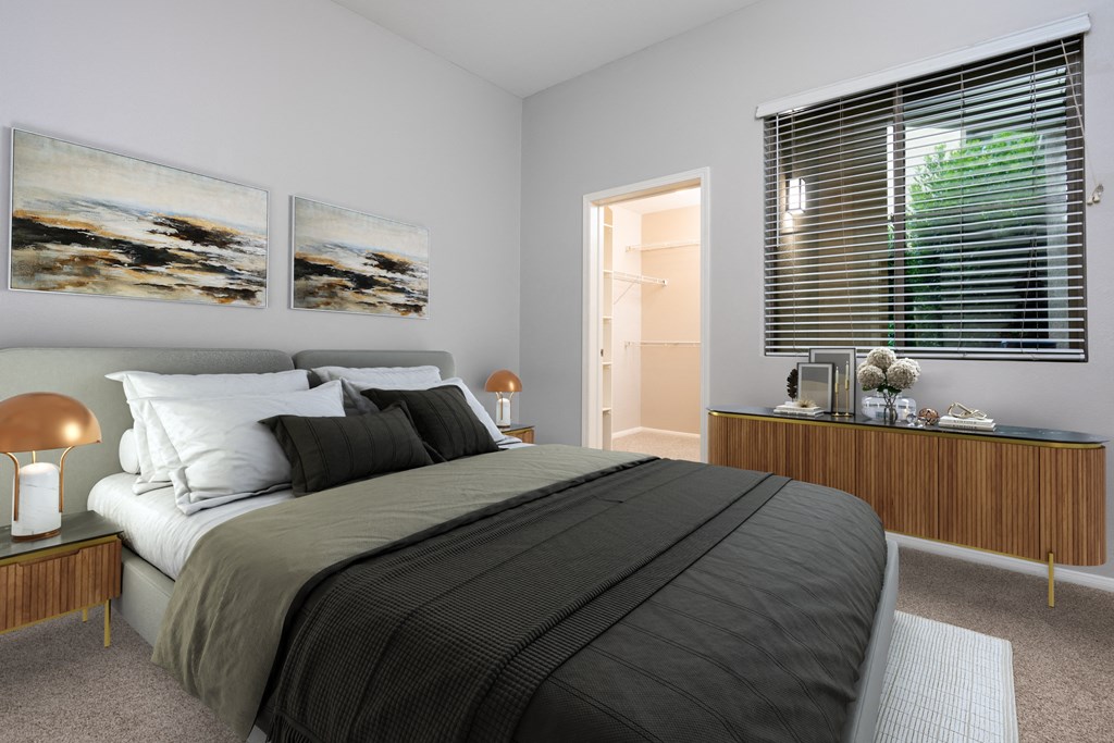 a bedroom with a bed and two pictures on the wall