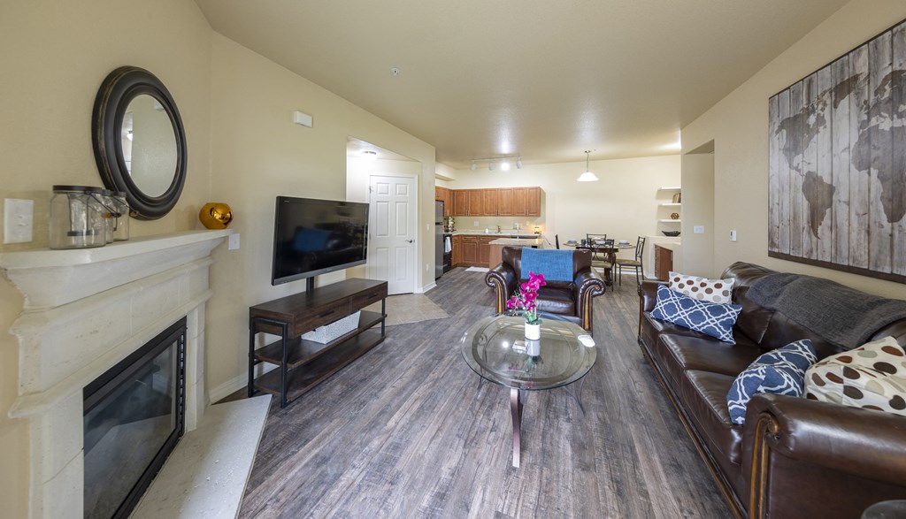 a living room with a fireplace and a couch and a table