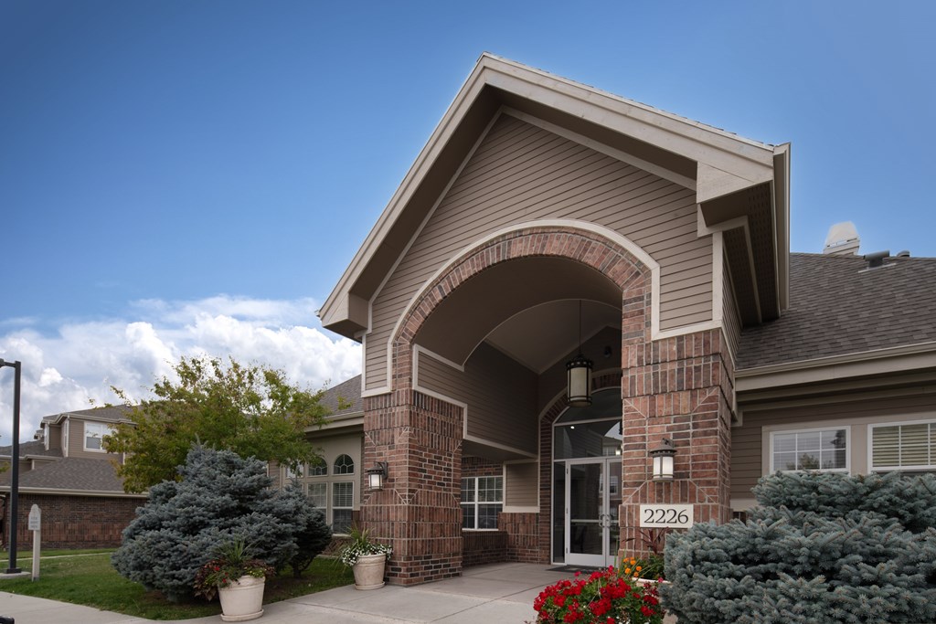 A house numbered 2226 with a front yard and a clear sky.