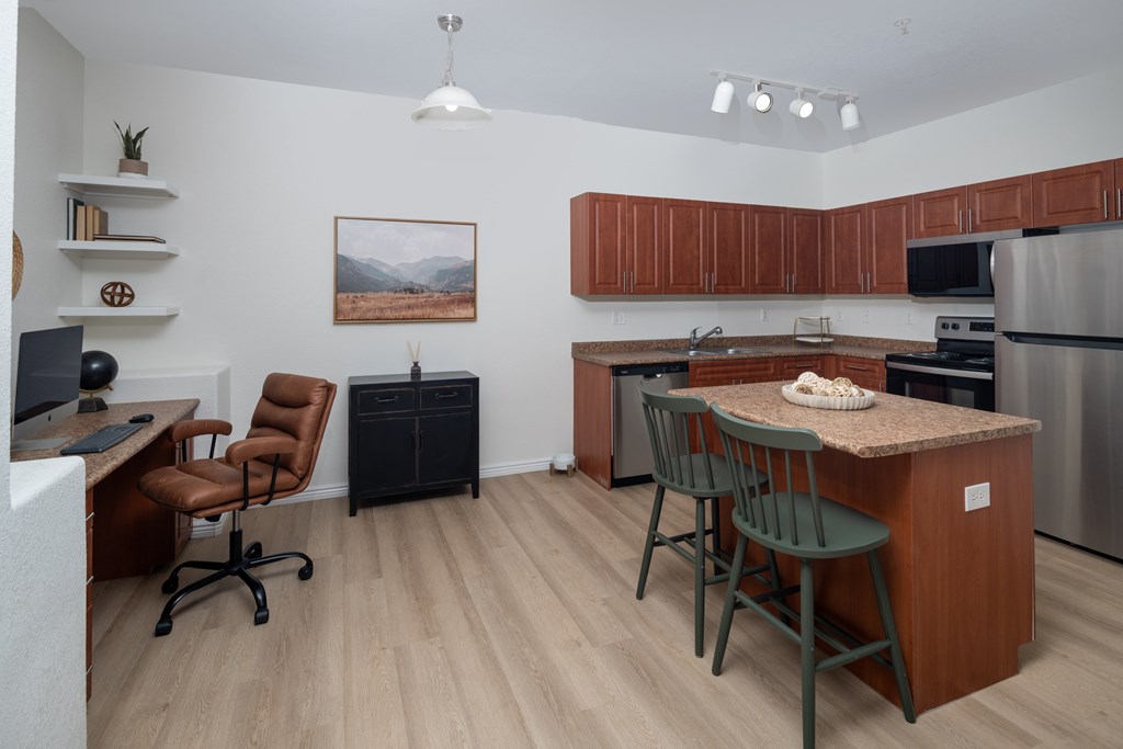A kitchen with a brown counter and a fridge.
