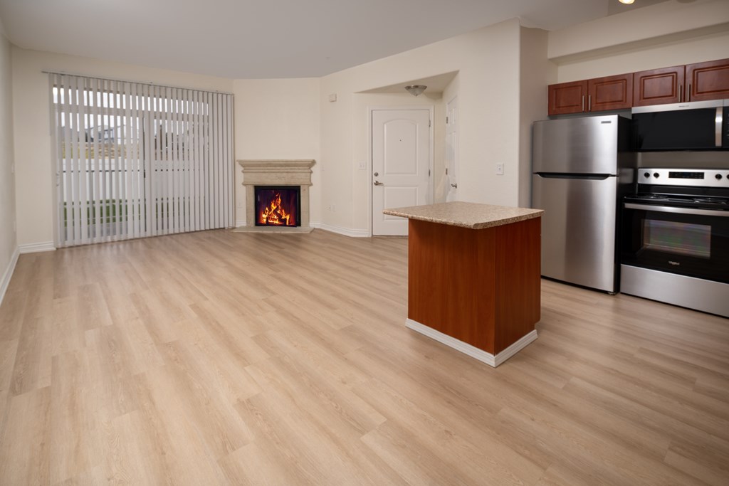A kitchen with a wooden island and stainless steel appliances.