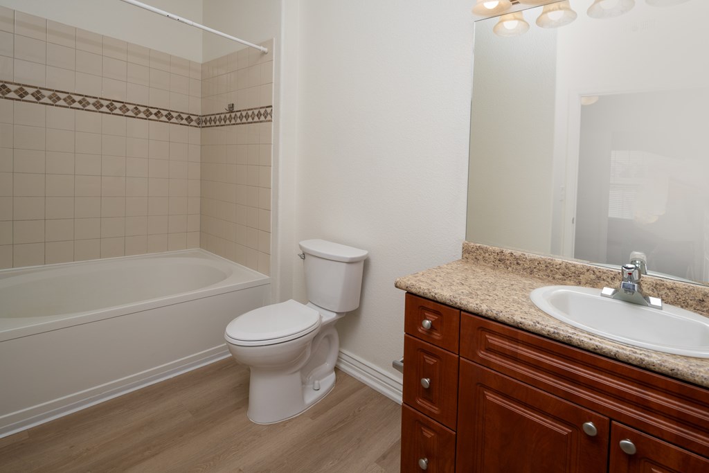 A white toilet sits next to a sink in a bathroom.