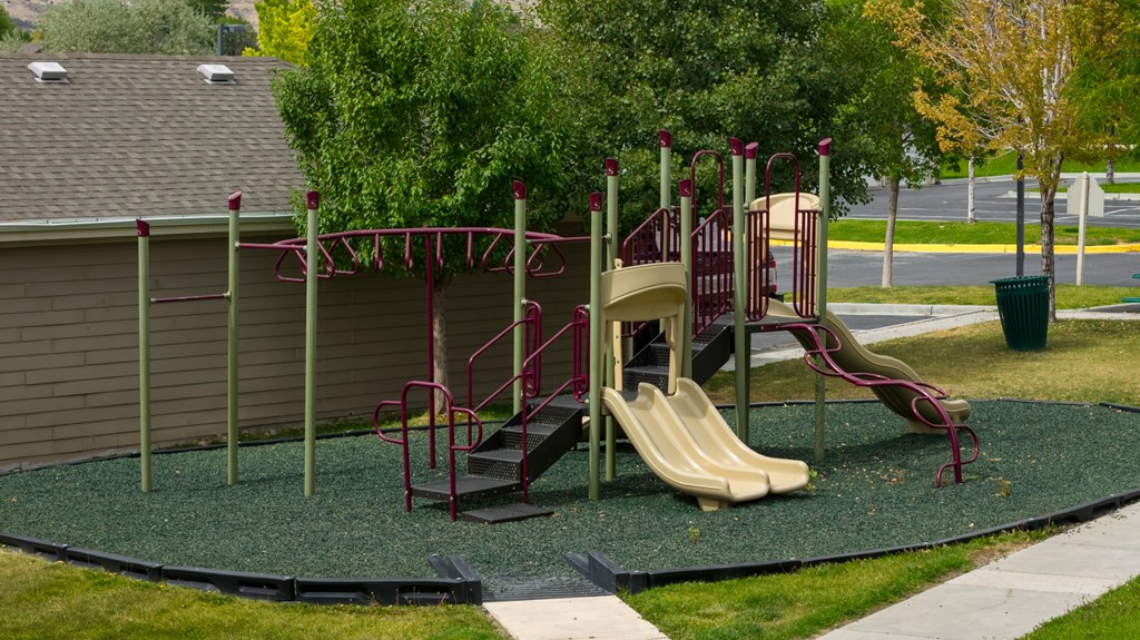 A playground with a slide and a climbing frame.