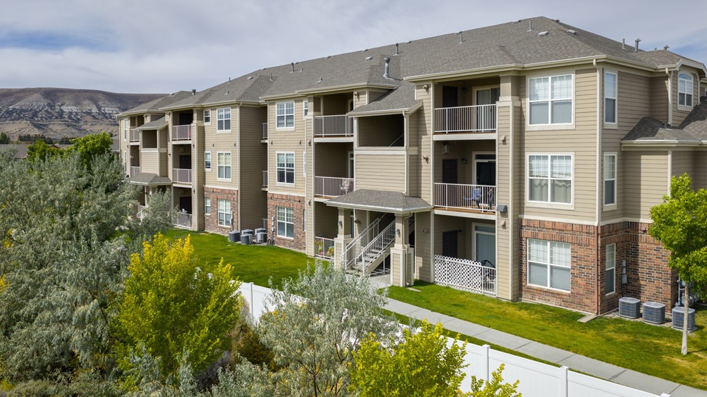 A large apartment complex with a mountain in the background.