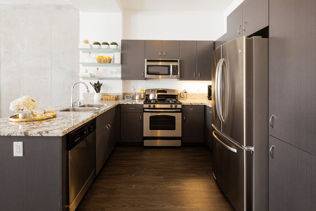 a kitchen with stainless steel appliances and granite counter tops
