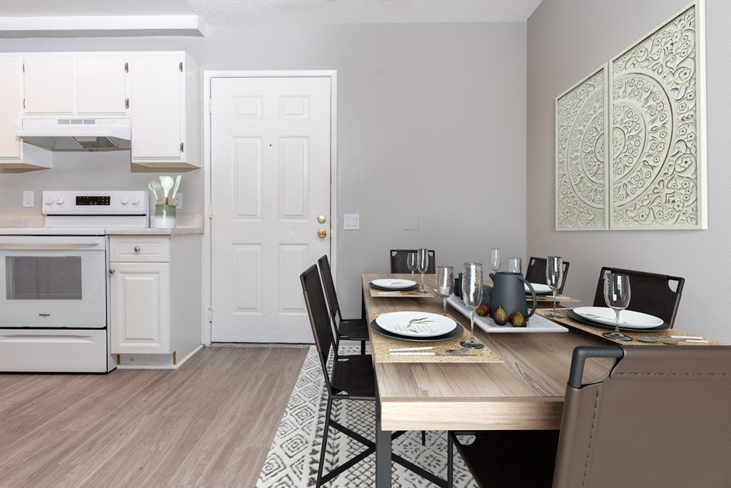 A dining room with a table set for two.