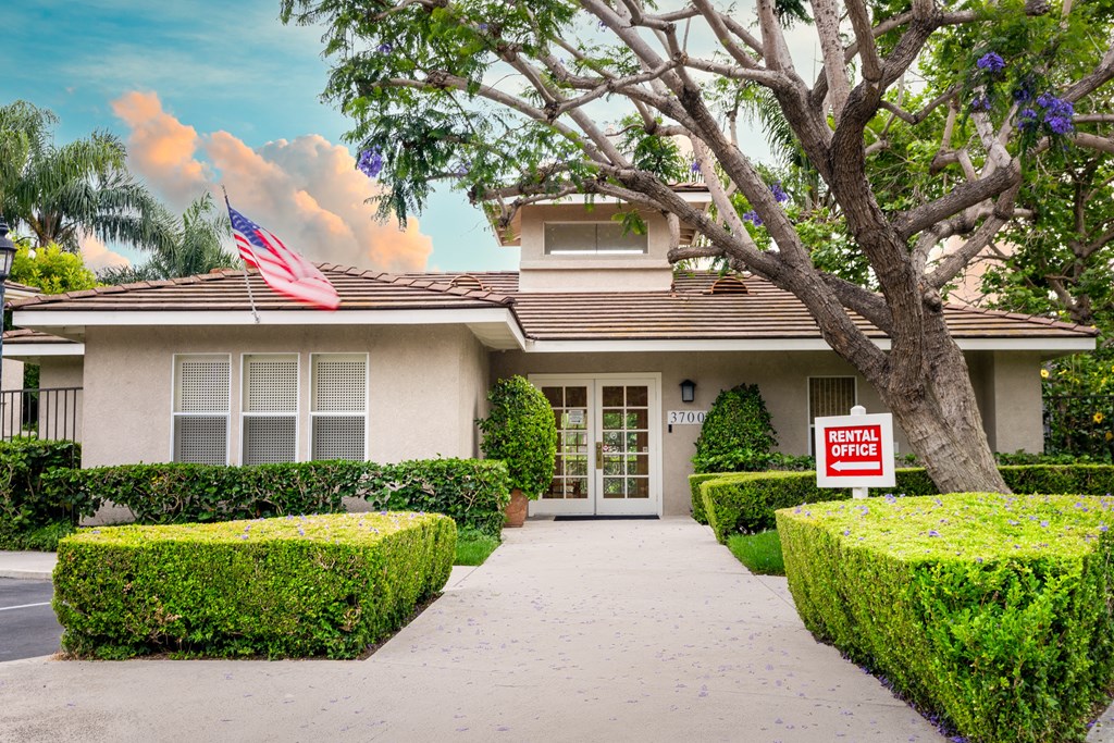 a house with a flag and a lease sign in front of it