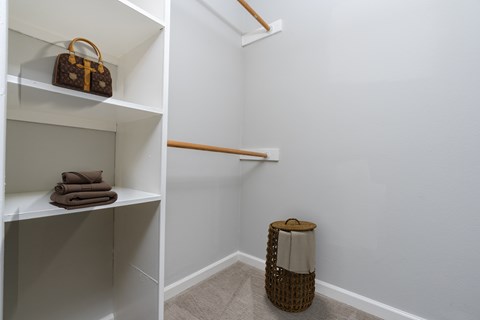 A white shelf with a brown bag on top of it.