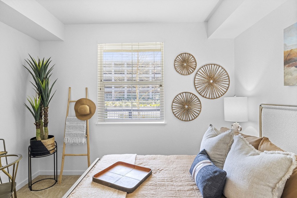 The Edge Milpitas CA a bedroom with a bed and a window