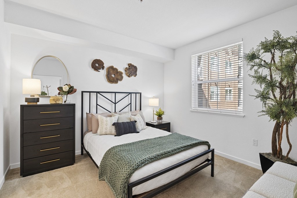 The Edge Milpitas CA a bedroom with a bed and dresser in a 555 waverly unit