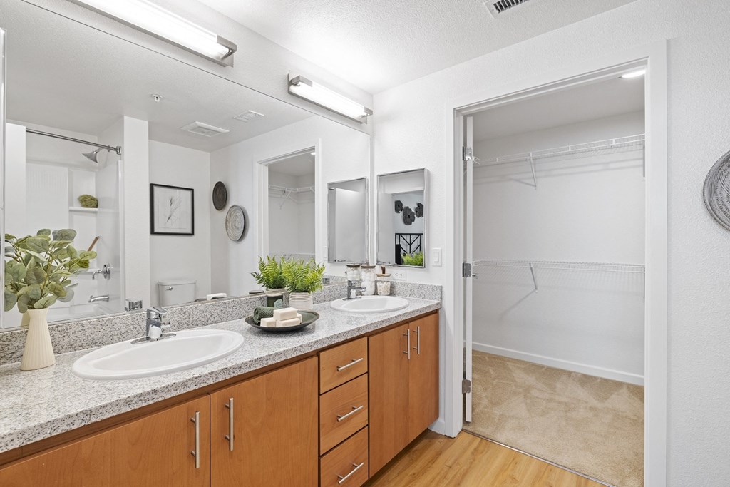 The Edge Milpitas CA a bathroom with two sinks and a walk in shower