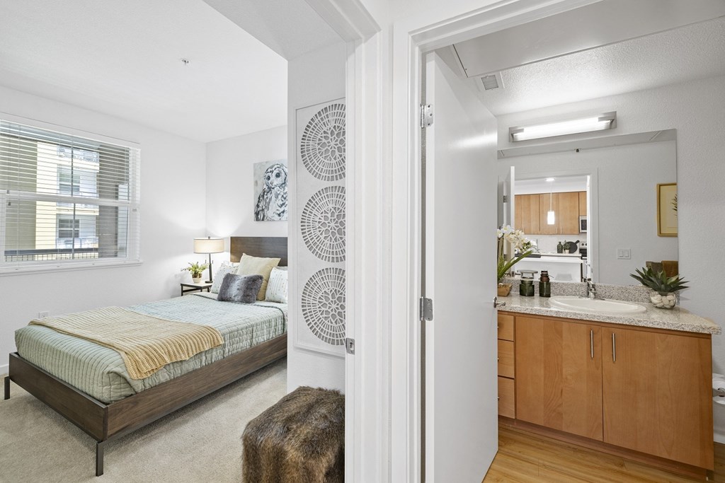 The Edge Milpitas CA a bedroom with a bed and a sink in a room
