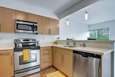 A kitchen with wooden cabinets and stainless steel appliances.