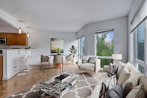 A living room with a couch, chairs, and a coffee table.
