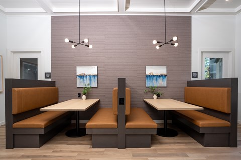 A dining area with two booths and a table in the middle.