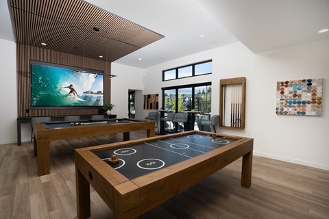 A room with a pool table and a television.
