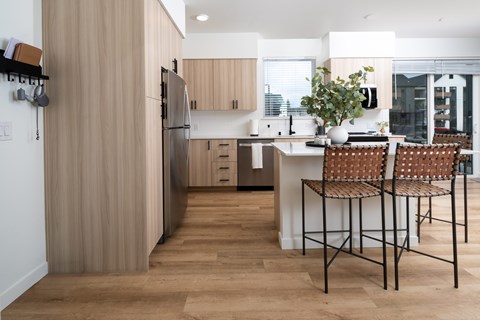 A kitchen with a table and chairs.