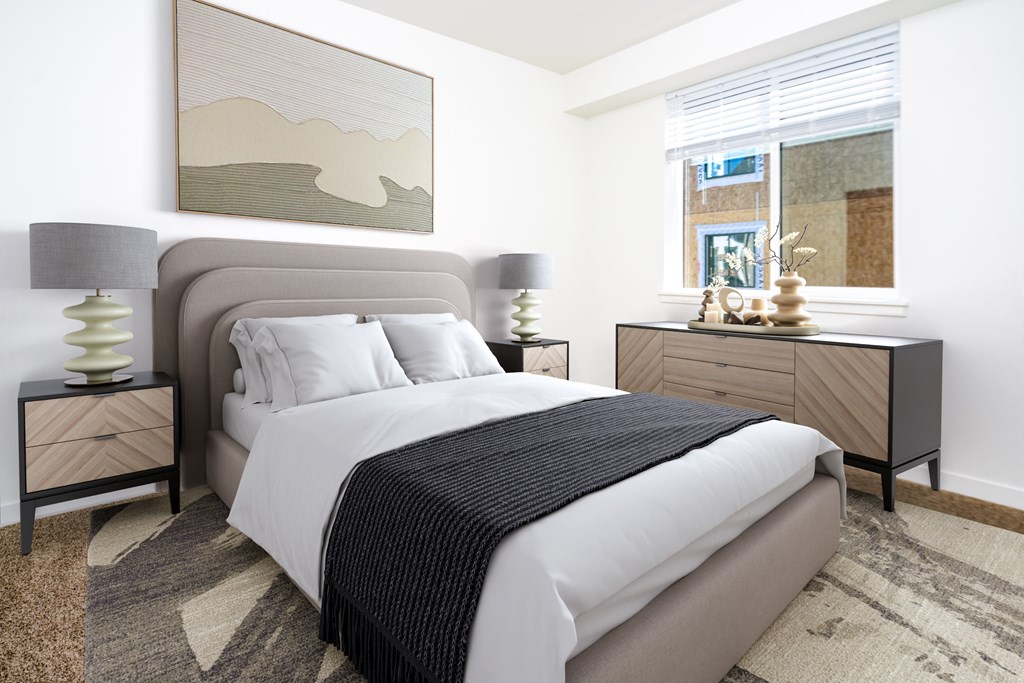 A bedroom with a large bed and a painting on the wall.