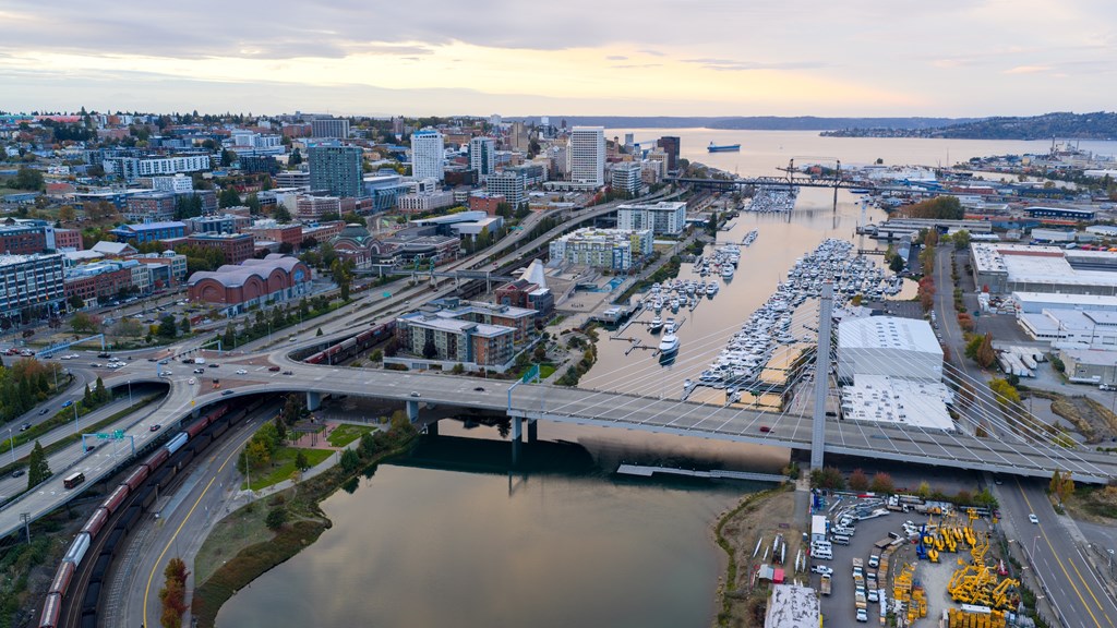A cityscape with a river and a bridge.
