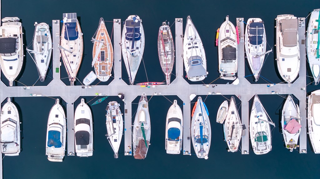 A collection of boats are moored in a marina.