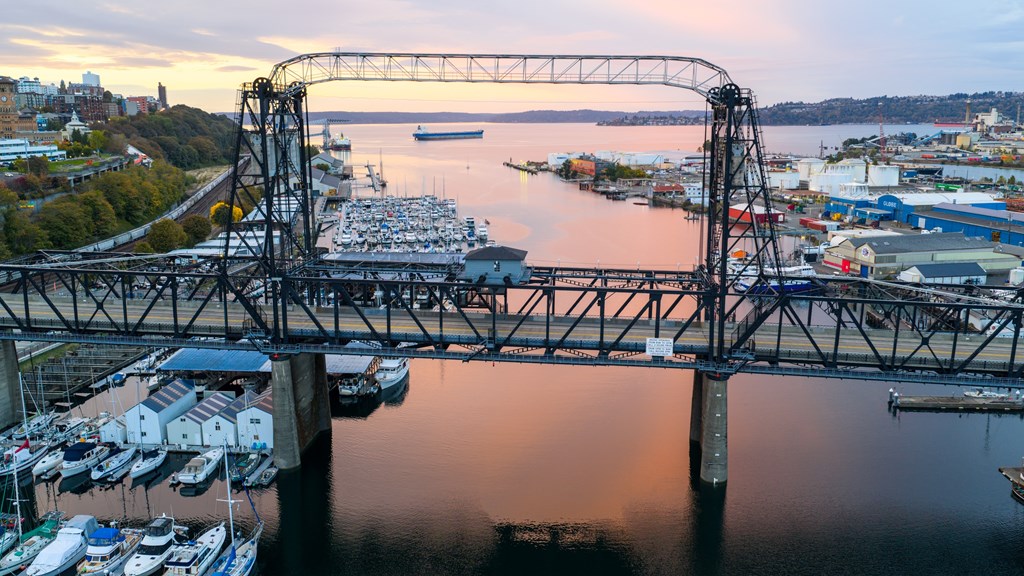 A bridge over a marina with boats docked in the water.