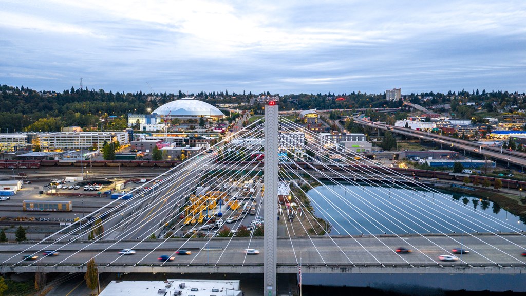 A busy multi-level highway interchange with cars and trucks moving in various directions.
