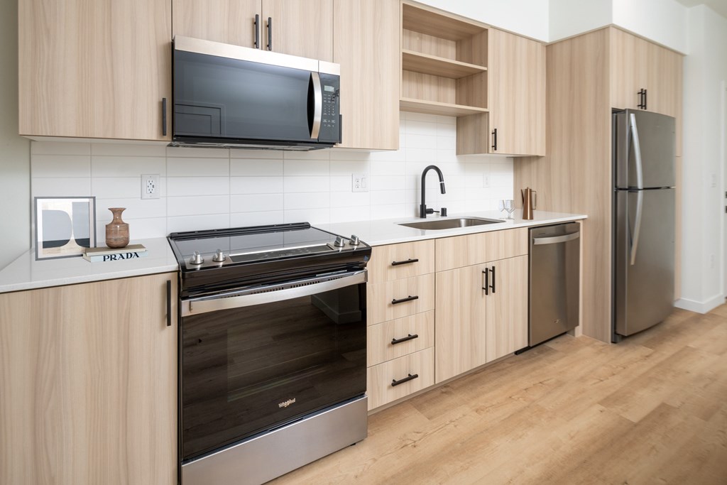 A kitchen with wooden cabinets and stainless steel appliances.